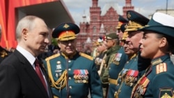 In a photo distributed by Russian state agency Sputnik, Russian President Vladimir Putin greets military commanders after the Victory Day military parade on Red Square in Moscow on May 9.