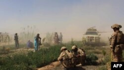 Afghan National Army commandos and Afghan militia forces take position during a military operation in Helmand in 2016.