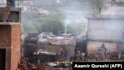 Soldiers cordon off the site where a Pakistani Army Aviation Corps aircraft crashed in Rawalpindi on July 30.