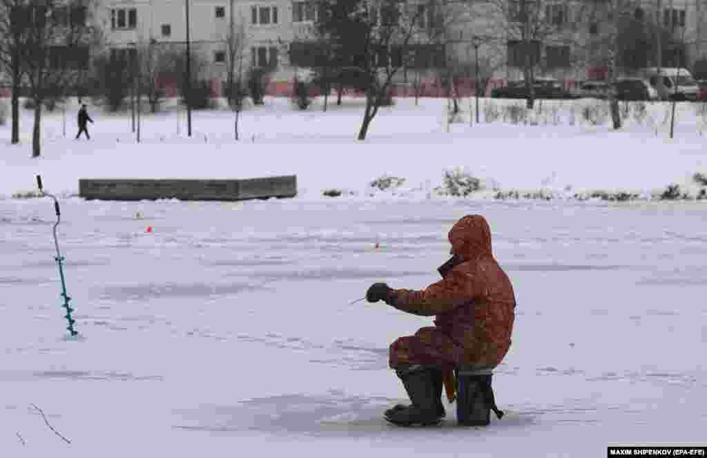  A man fishes on a frozen pond at a residential area in Moscow. &nbsp; 