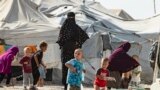 SYRIA -- Women look after children at the Kurdish-run Al-Hawl camp for the displaced where families of Islamic State (IS) foreign fighters are held, in the al-Hasakeh governorate in northeastern Syria, October 17, 2019