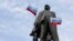 Ukraine -- Pro-Russian demonstrators stand at a statue of Soviet state founder Vladimir Lenin as they attend a rally in Donetsk, March 9, 2014