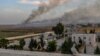 Smoke rises from the Syrian town of Tal Abyad in a photo taken from the Turkish side of the border.