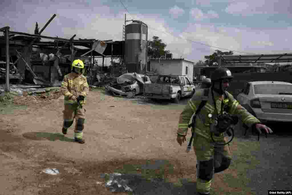 Emergency personnel respond after a rocket apparently fired from Gaza hits Kfar Chabad near Tel Aviv on October 7.