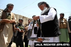 Former warlord Ismail Khan with his militiamen in the western city of Herat.