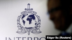 NIGERIA-CRIME/A man passes an Interpol logo