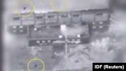 A screen grab from a video of an undated material released by the Israeli military on March 21, 2018 shows yellow circles depicting bombs during what the military describes is an Israeli air strike on a suspected Syrian nuclear reactor site near 