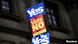 U.K. -- Posters for and against Scotland's independence fly from a pole in Clydebank (Scotland referendum)