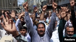 Pakistani Shi'ite Muslims in Karachi raise their hands and chant slogans as they attend an anti-Israel protest on June 13 following its strikes on Iran. 