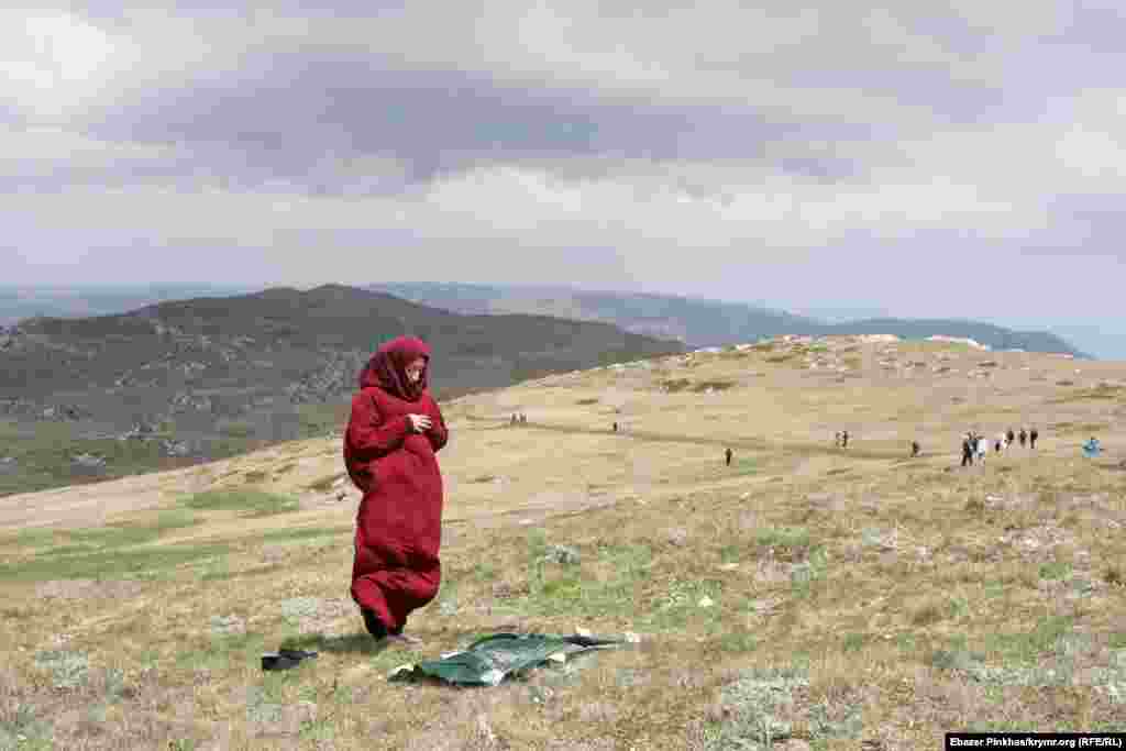 A woman on Mount Chatyr-Dag in Crimea, Ukraine, on May 16. Crimean Tatar youth climb the mountain every year to honor the memory of those who died during the deportation of Crimean Tatars in 1944.