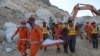 Army rescuers move the body of a miner from the site after a rockslide at a marble mine in the mountainous Mohmand district of Khyber Pakhtunkhwa Province.