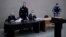 A video feed from the penal colony shows Aleksei Navalny (standing) during the court hearing in the town of Pokrov last month.
