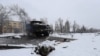 The burned-out hulk of a Russian Grad missile launcher and the body of a soldier near Kharkiv on February 25.