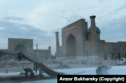 A worker disappears behind a cloud of stone dust during reconstruction of Samarkand’s Registan Square in 2013.