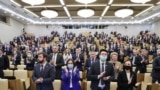 Russia -- Attendees stand during a plenary meeting of the Russian State Duma