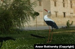A statue of a stork placed in front of a religious school in Bukhara.
