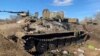 A handout photo from the Ukrainian Defense Ministry shows a damaged Russian armored personnel carrier near Kharkiv on February 24.&nbsp;