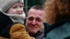 UKRAINE-SLOVAKIA-BORDER - A man holding a child reacts as they arrive from Ukraine to Slovakia, after Russia launched a massive military operation against Ukraine, in Ubla, Slovakia, February 25, 2022