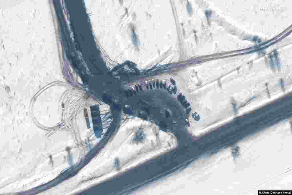 Self-propelled artillery in a convoy at the entrance to the Kursk training area in Russia on February 14.