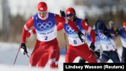 Aleksandr Bolshunov and Artyom Maltsev of the Russian Olympic Committee cross-country skiing in February 2022.