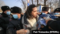 Protesters are detained by police during an anti-war picket at the Russian Consulate in Almaty on February 24.