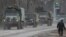 Russian Army military vehicles drive along a street in Armyansk on February 24.