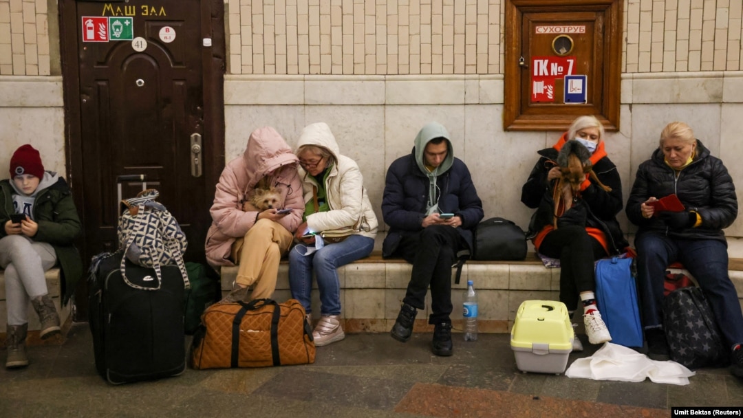 People gather at a subway station in Kyiv on February 24 as they seek shelter from expected Russian air strikes. 