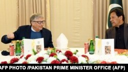 Pakistan's Prime Minister Imran Khan (right) speaks with Bill Gates in Islamabad on February 17.