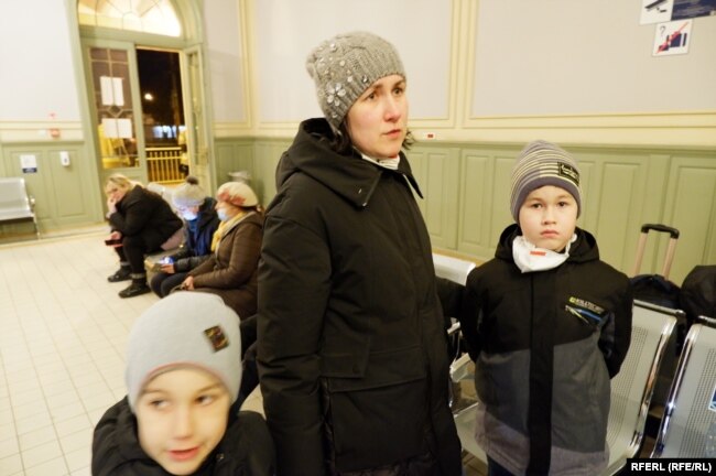 Tetyana and her two sons inside the train station in Przemysl, Poland. "My heart is broken -- to think of my husband and everything, all the relatives we have left in Ukraine," she says.