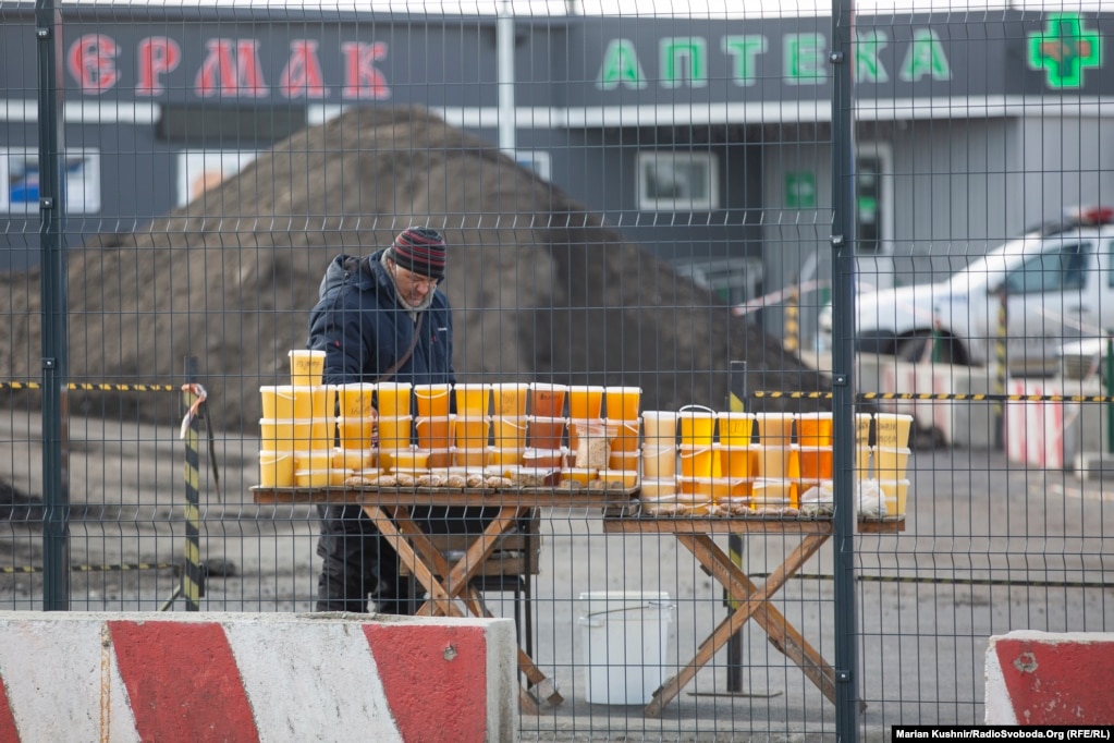 A beekeeper who gave his name only as Anatoliy sells honey, beeswax, and other products at the administrative border checkpoint at Stanytsya Luhanska.