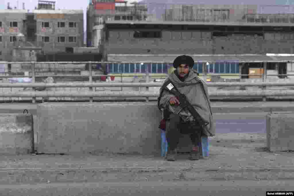 A Taliban fighter on guard along a road in Kabul.