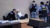 Jailed opposition politician Aleksei Navalny (left) talks to his wife in court on February 15. (file photo)