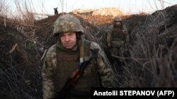 UKRAINE - Ukrainian soldiers walk along tranches on their position on the front line with Russia backed separatists in Donetsk region, February 21, 2022