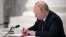 Russian President Vladimir Putin signs documents, including a decree recognizing two Russian-backed separatist formations in eastern Ukraine as independent entities during a ceremony in Moscow on February 21. 