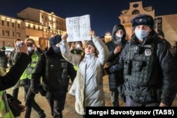 Police detain a demonstrator holding a sign reading "No to war with Ukraine" at an unsanctioned anti-war protest in Pushkin Square in central Moscow on February 24, the day that Russia began its invasion.