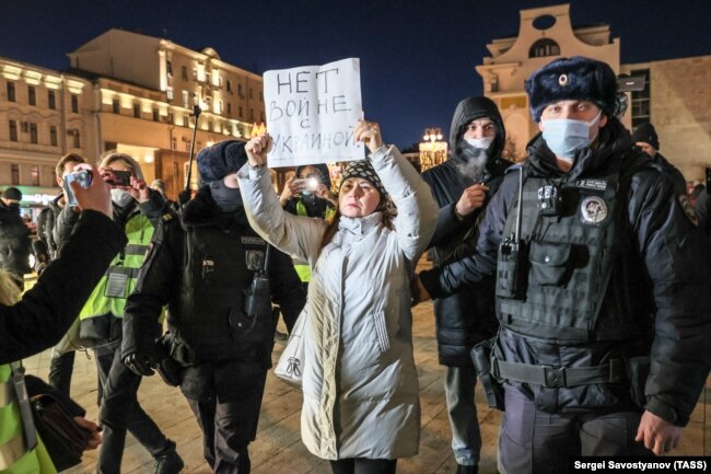 Police detain a demonstrator holding a sign reading "No to war with Ukraine" at an unsanctioned anti-war protest in Pushkin Square in central Moscow on February 24, the day that Russia began its invasion.