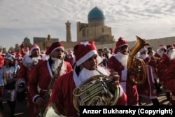 A parade of musical Santas marches through Bukhara in 2019.