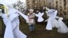 A girl looks at symbolic paper angels paying tribute to the &quot;Heroes of the Heavenly Hundred,&quot; referring to those killed during anti-government demonstrations in early 2014, during a memorial event near Kyiv&#39;s Independence Square, known as the Maidan, on February 18.