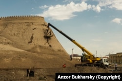 Workers repairing already restored walls of an ancient fortress in Bukhara in 2019.