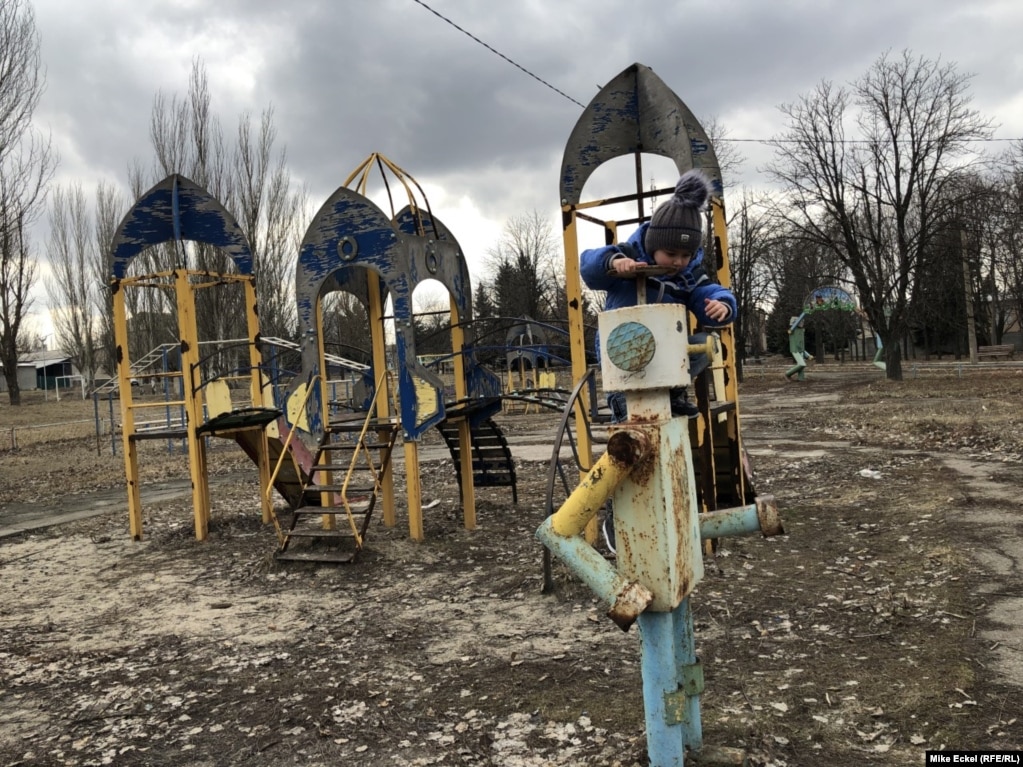 Six-year-old Zhenya plays on a decrepit school playground in the center of the front-line town of Novoluhanske, Ukraine, on February 19,. The town is a shell of its former self, with everyone having moved away, according to his father, Serhiy Kraynov.