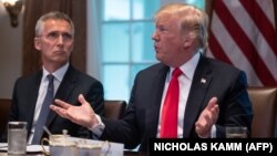 U.S. President Donald Trump (right) speaks during a meeting with NATO Secretary-General Jens Stoltenberg at the White House on May 17.