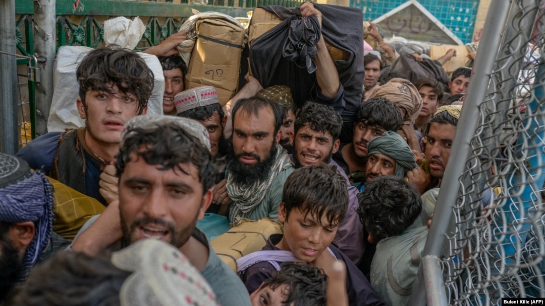Afghans rush to pass through the border gate into Pakistan at Spin Boldak in September.