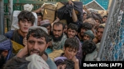 Afghans rush to pass through the border gate into Pakistan at Spin Boldak in September.