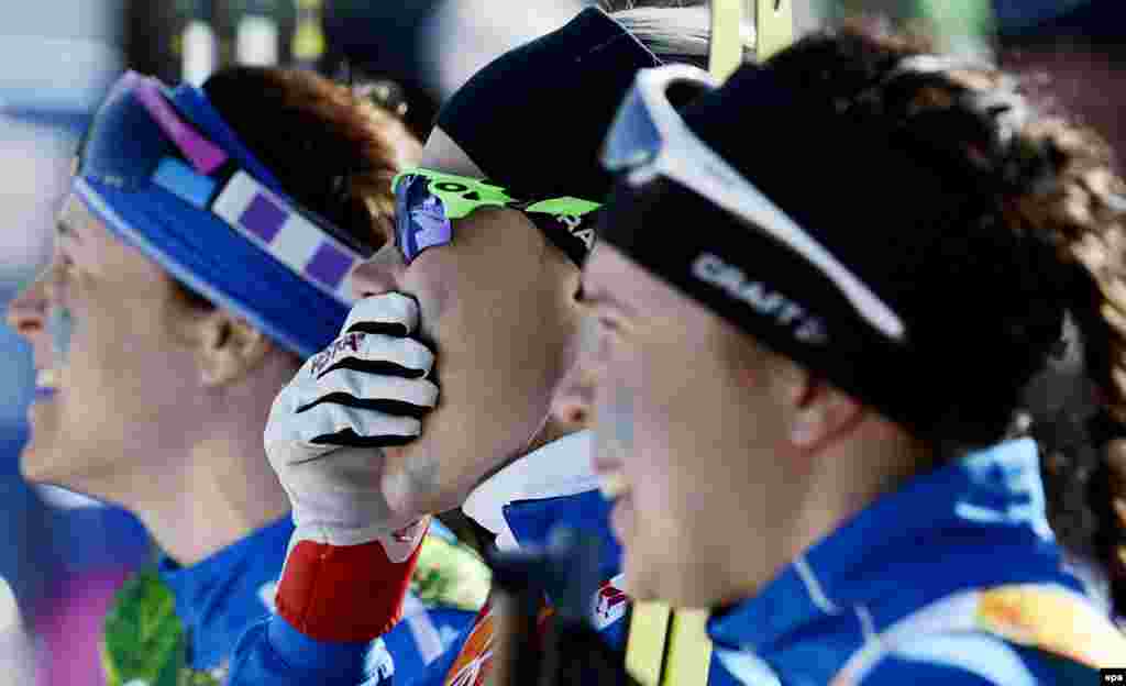 Finland&#39;s Anne Kylloenen (center) Aino-Kaisa Saarinen (left) and Kerttu Niskanen of Finland react at the finish line during the women&#39;s cross-country 4 x 5km relay competition. Finland won silver. (EPA/Filip Singer)