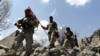 Afghan security forces survey a village in Nangarhar's Kot district after reclaiming it from the Islamic State militants.