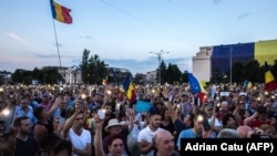 People participate in a protest in front of the prime minister's office in Bucharest on June 20.