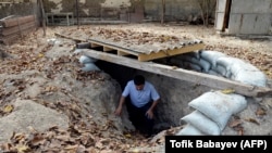 A man gets out of a makeshift bomb shelter in the village of Sahlabad outside the Azerbaijani city of Tartar on September 29.