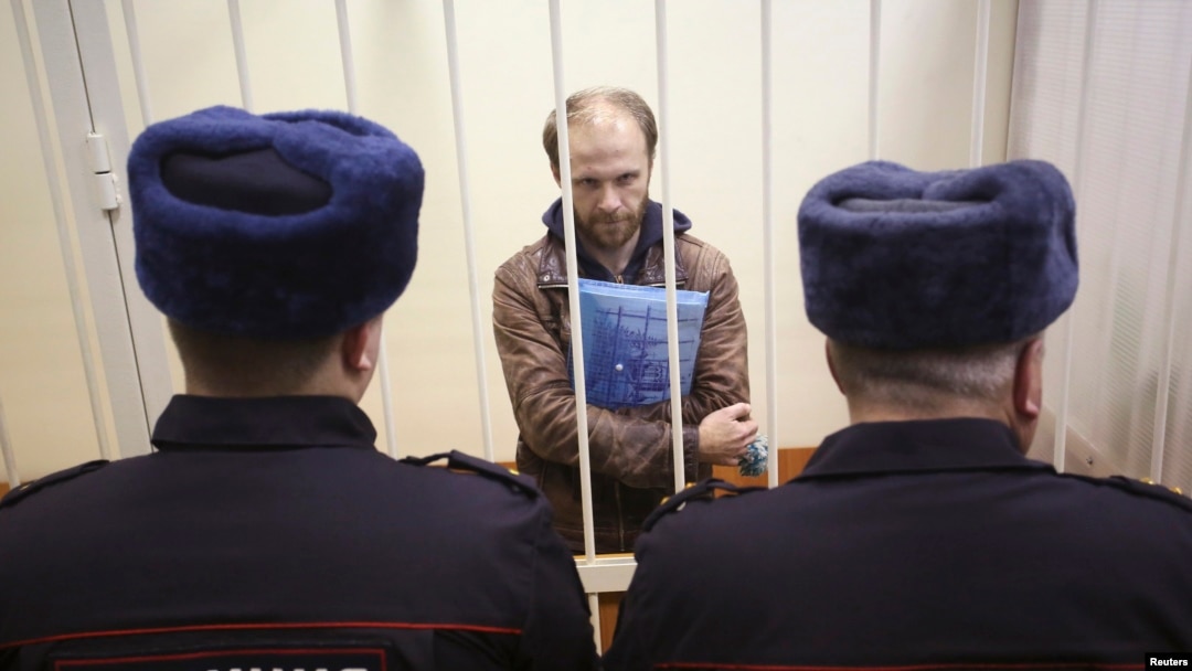 Russian photographer Denis Sinyakov stands in the dock during a court session in St. Petersburg on November 18, at which his bail was set at around $61,000.