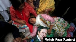 A supporter of Pakistani Prime Minister Nawaz Sharif passes out after the Supreme Court's decision to disqualify Sharif in Lahore on July 28.
