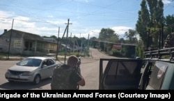 Staff sergeant Maks Bondarenko attempts to shoot down a Russian FPV quadcopter moments before it targeted a vehicle in Kramatorsk on July 15.